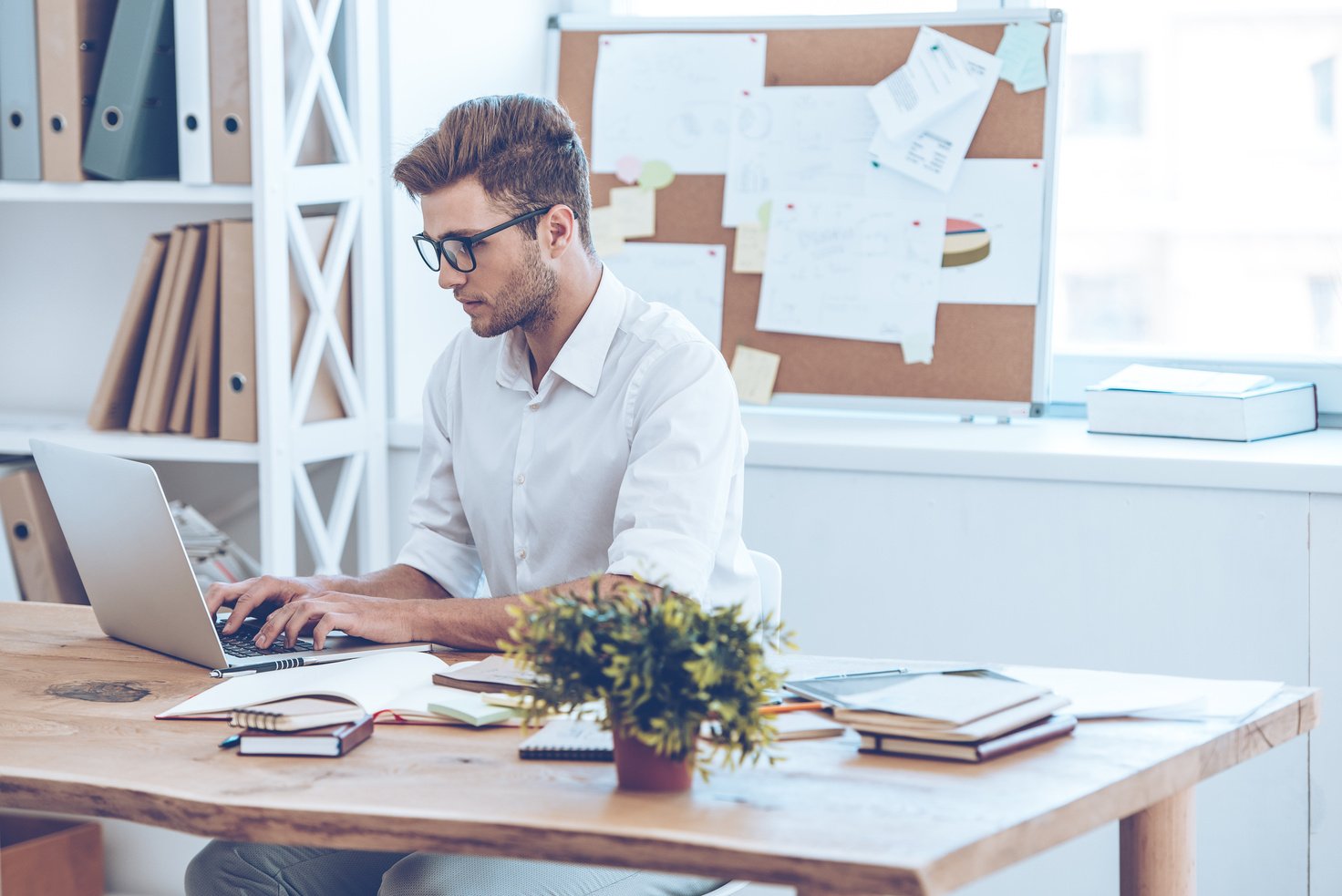 Sending email to his coworkers.