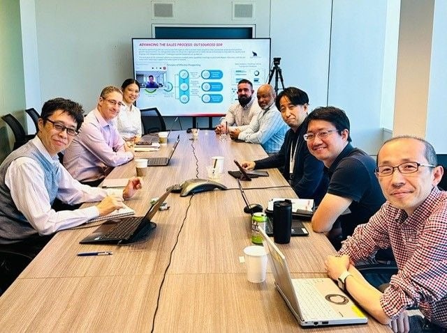 A diverse group of professionals collaborating in a modern conference room.