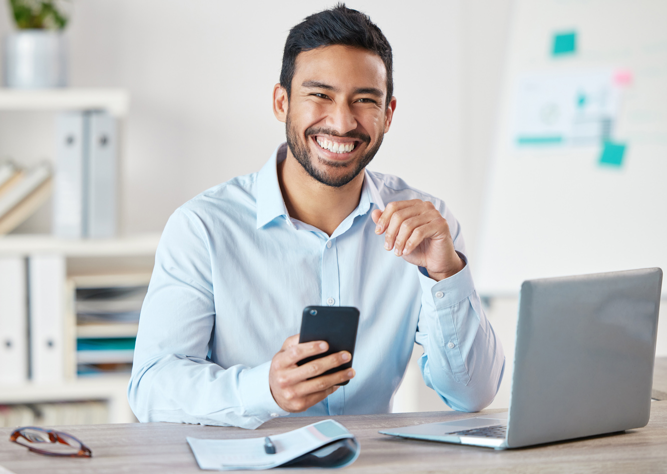 Simile, Phone and Portrait of Business Man in a Office with Startup and Technology. Motivation, Worker and Happiness of Businessman with Insurance Agency Work with Mobile Text and Development at Job